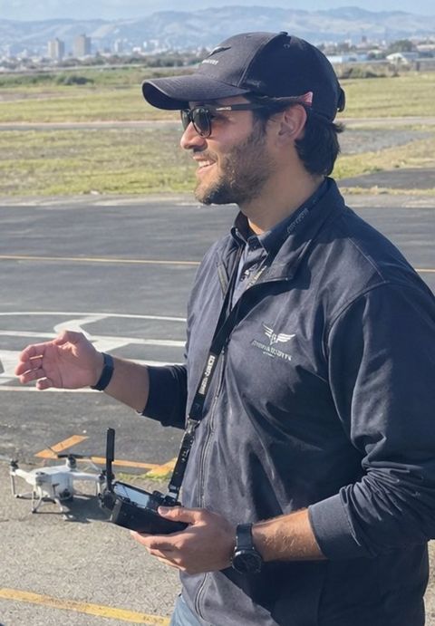 Max Bennedeto, Part 107 instructor, with a drone controller at the airfield
